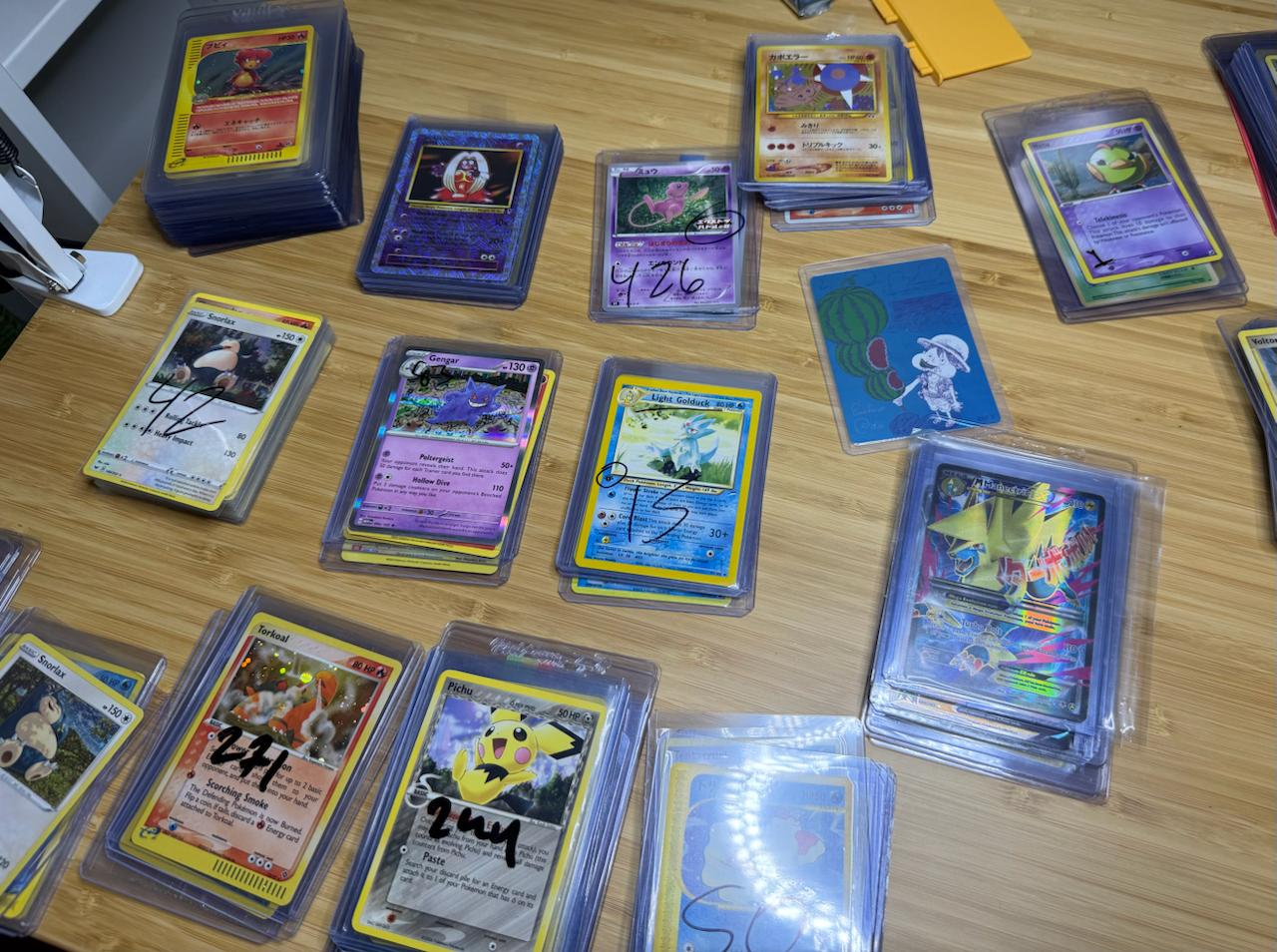 Pokemon cards sorted on a table for Card Consignor consignment review