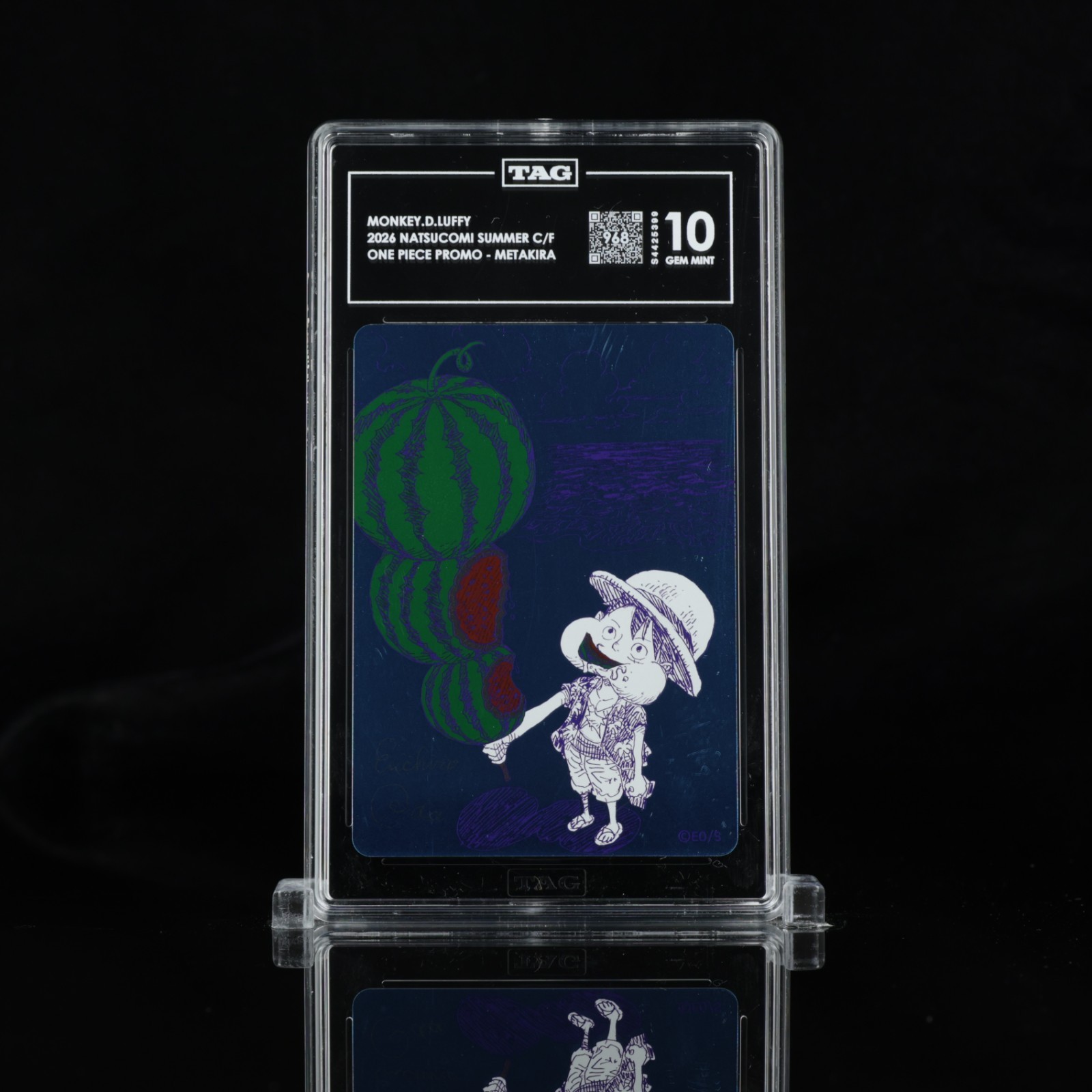 TAG 10 Watermelon Luffy One Piece promo slab photographed on a black reflective surface
